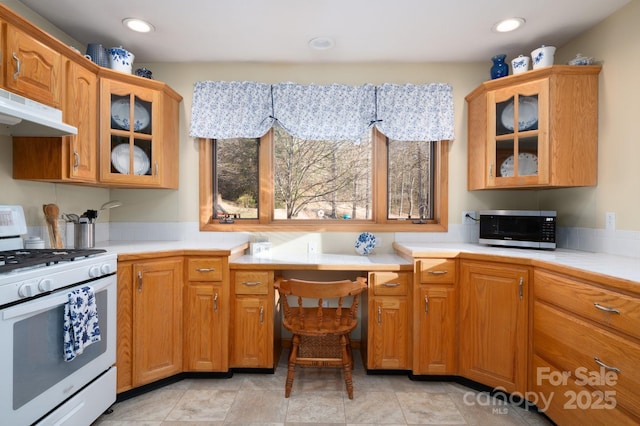 kitchen with built in desk and white gas stove