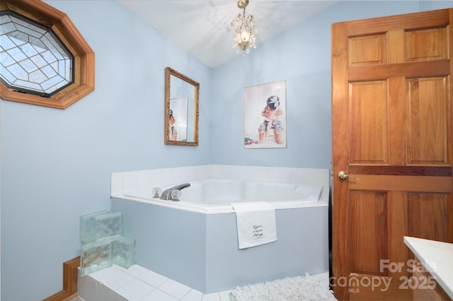 bathroom with lofted ceiling, a tub, and a chandelier