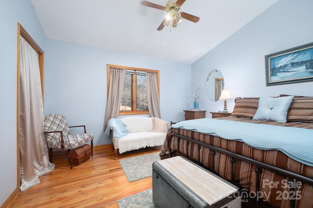 bedroom featuring wood-type flooring, lofted ceiling, and ceiling fan