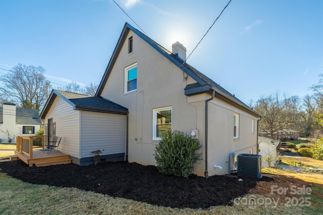 back of house with a wooden deck and central AC unit