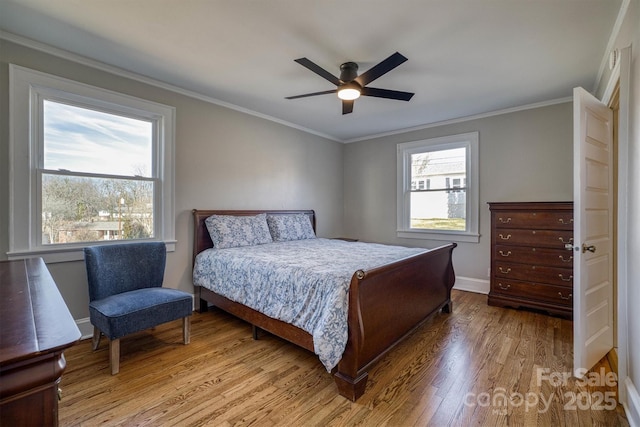 bedroom with crown molding, ceiling fan, and light hardwood / wood-style flooring