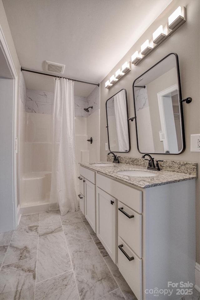 bathroom featuring vanity and walk in shower