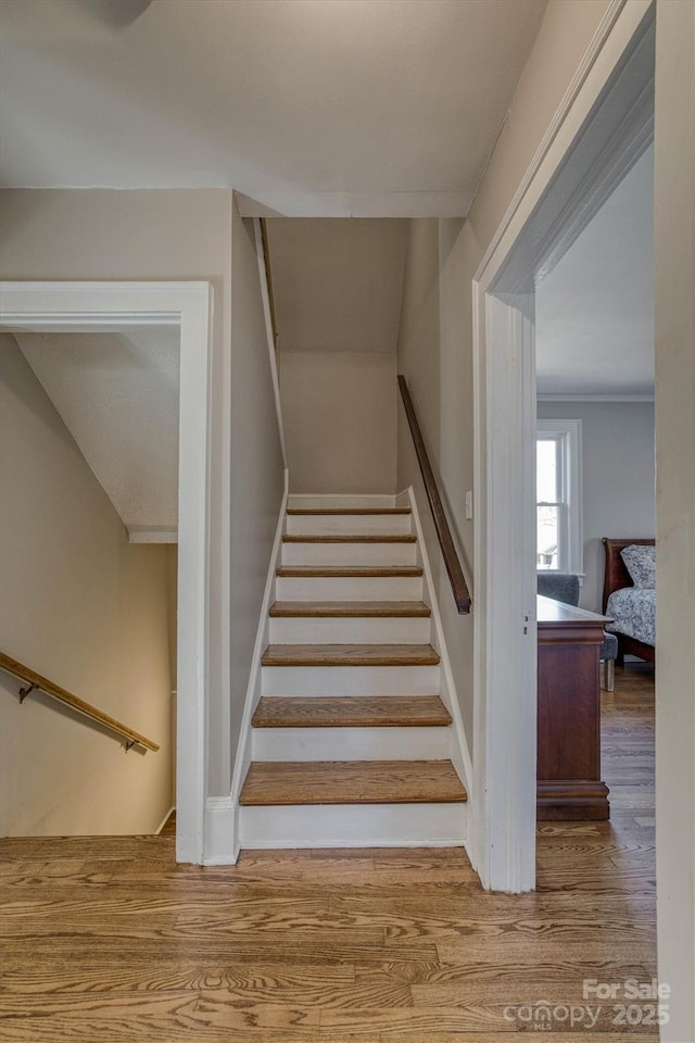 stairs featuring hardwood / wood-style flooring