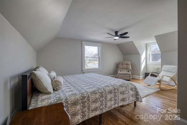 bedroom with hardwood / wood-style flooring, ceiling fan, and lofted ceiling