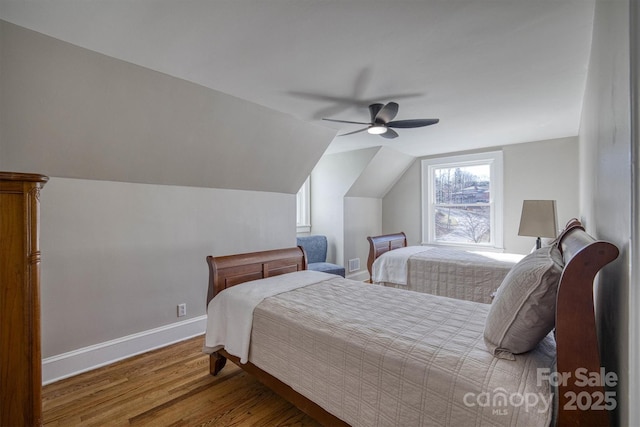 bedroom featuring hardwood / wood-style flooring, vaulted ceiling, and ceiling fan