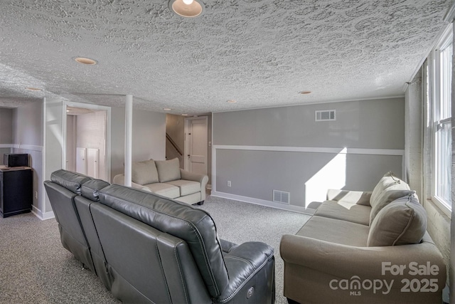 carpeted living room with a textured ceiling