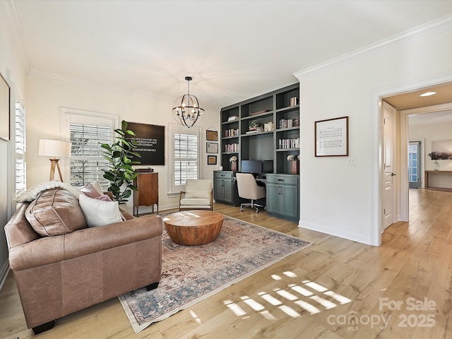 living room featuring built in features, light hardwood / wood-style flooring, crown molding, and a chandelier