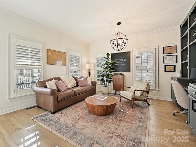 living room with crown molding, a chandelier, and light hardwood / wood-style flooring