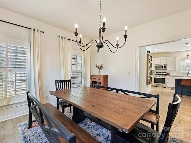 dining space featuring light hardwood / wood-style floors and sink