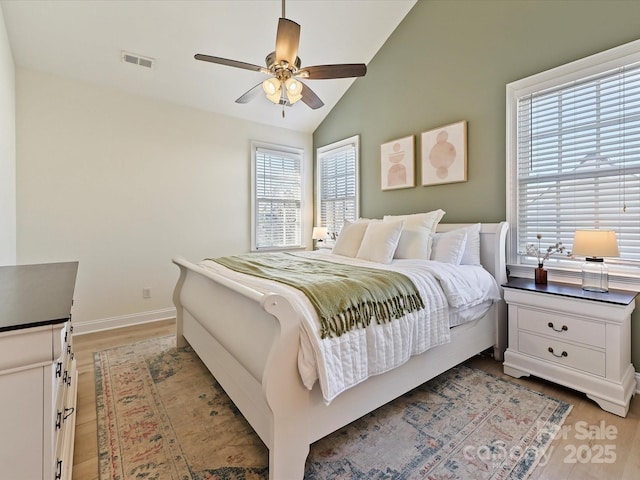 bedroom with lofted ceiling, light hardwood / wood-style flooring, and ceiling fan