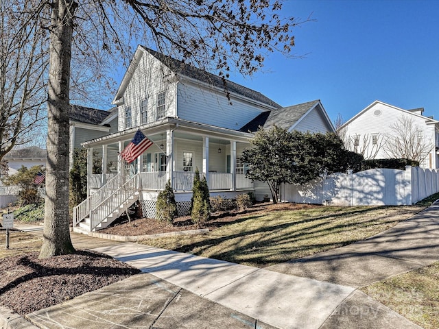 view of front of house featuring covered porch and a front lawn