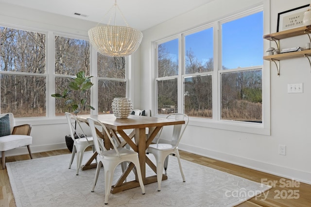 sunroom / solarium with a chandelier