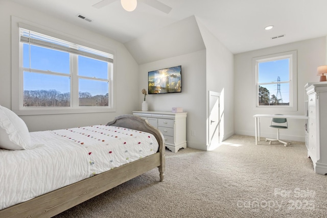 carpeted bedroom with vaulted ceiling and ceiling fan