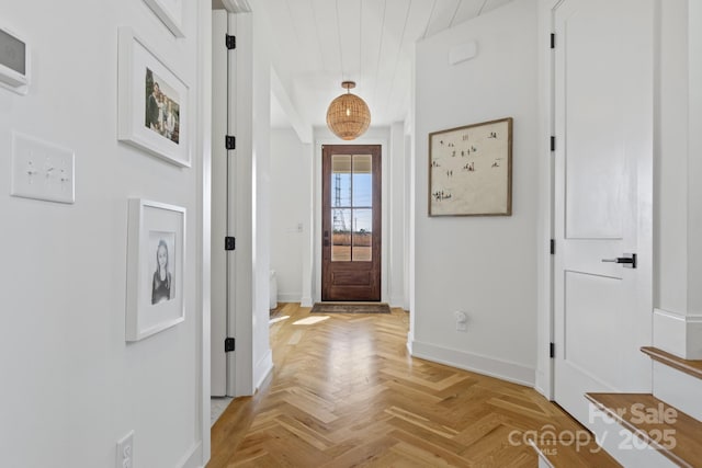 entryway with wooden ceiling and light parquet floors