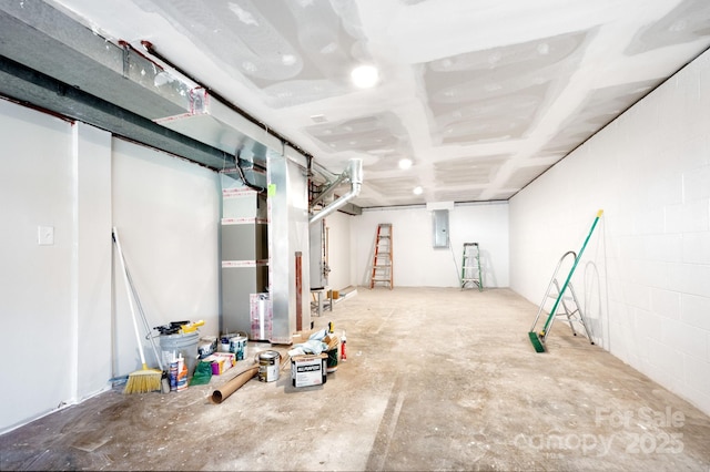 basement featuring concrete block wall and electric panel
