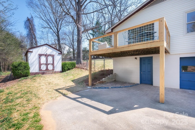 view of home's exterior featuring a deck, an outdoor structure, and a storage shed