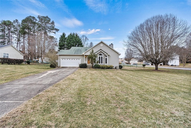 view of front of home with a garage and a front lawn