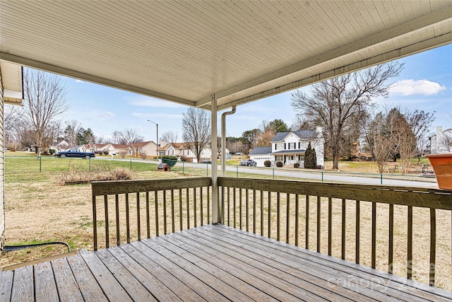 wooden terrace featuring a lawn