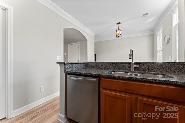 kitchen with ornamental molding, dishwasher, sink, and dark stone countertops