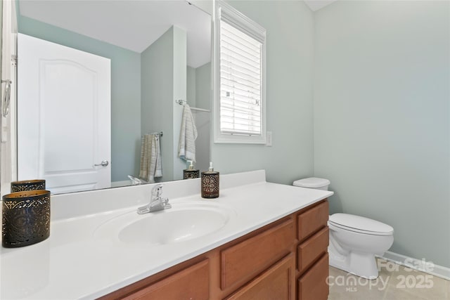 bathroom with vanity, toilet, and tile patterned flooring