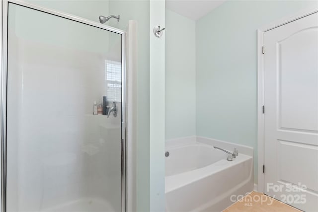 bathroom with separate shower and tub