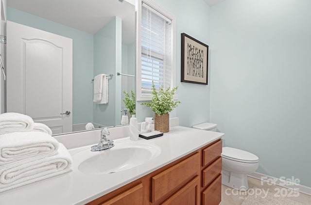 bathroom featuring vanity and toilet