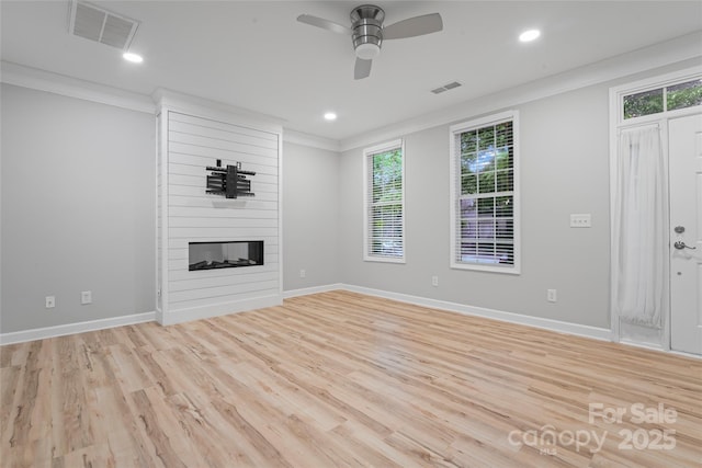 unfurnished living room featuring light wood-type flooring, plenty of natural light, a ceiling fan, crown molding, and recessed lighting