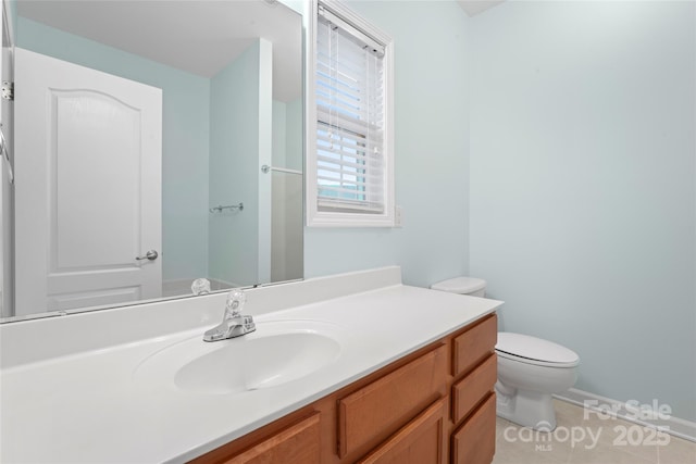 bathroom with vanity, toilet, and tile patterned floors