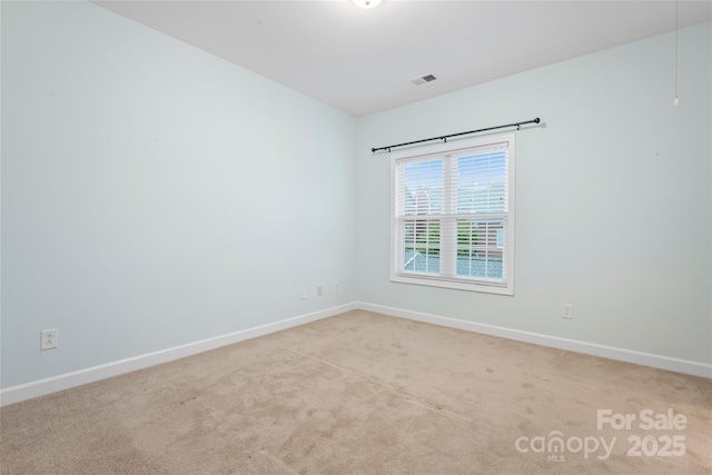 empty room featuring baseboards and carpet flooring