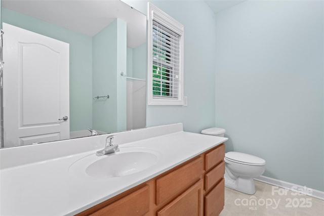bathroom with vanity, toilet, and tile patterned floors