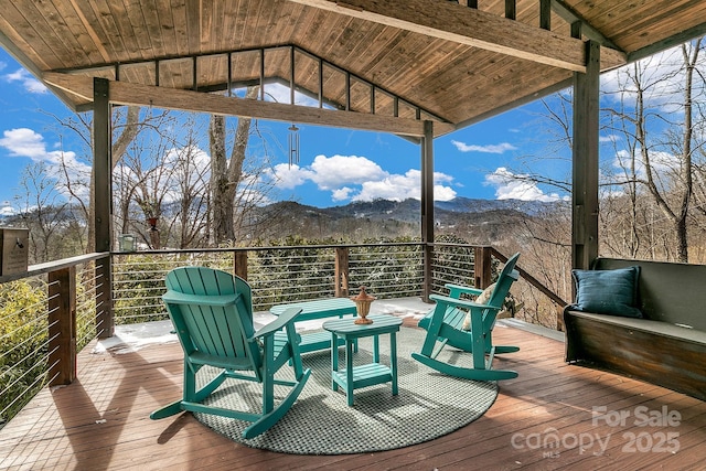 wooden deck with a mountain view