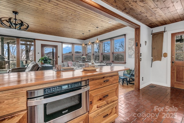 kitchen featuring butcher block counters, wood ceiling, wall oven, and decorative light fixtures