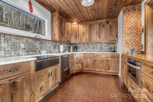 kitchen with stainless steel appliances, tasteful backsplash, sink, and wood ceiling