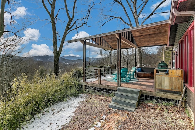 wooden deck with a mountain view and a grill