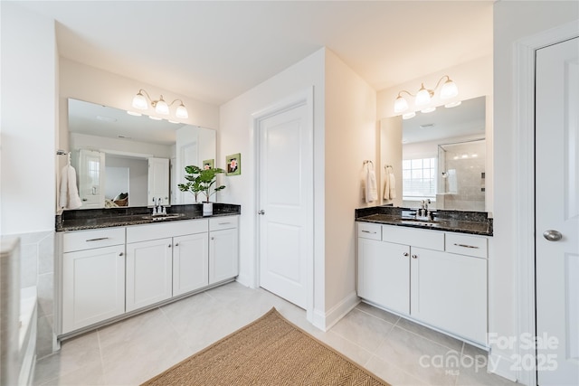 bathroom with vanity, walk in shower, and tile patterned flooring