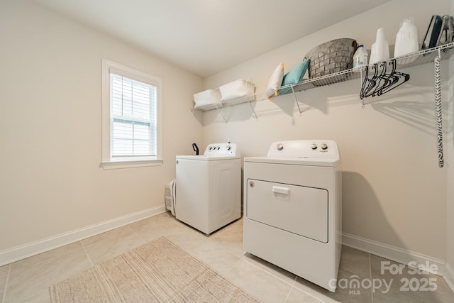 laundry area featuring light tile patterned flooring and separate washer and dryer