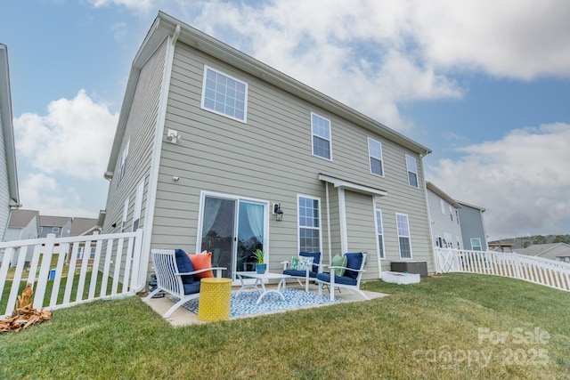 back of property featuring a patio area, a lawn, and central AC