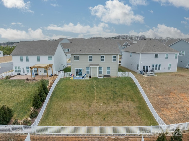 back of property featuring a patio area and a yard