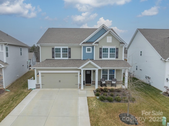 view of front of property featuring a garage and a front lawn