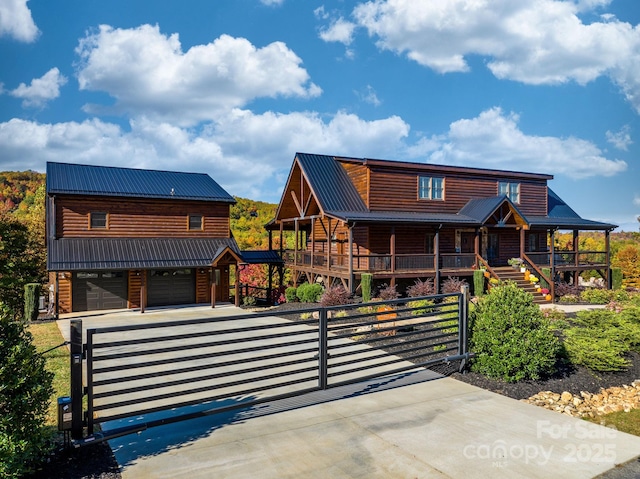 log-style house featuring a garage and a porch