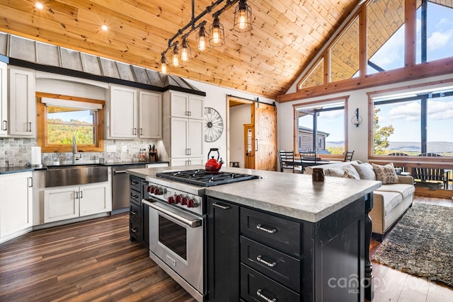 kitchen featuring wood ceiling, backsplash, appliances with stainless steel finishes, a kitchen island, and white cabinets