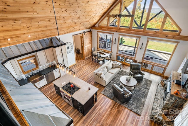 living room featuring wood ceiling, ceiling fan, high vaulted ceiling, and light hardwood / wood-style flooring