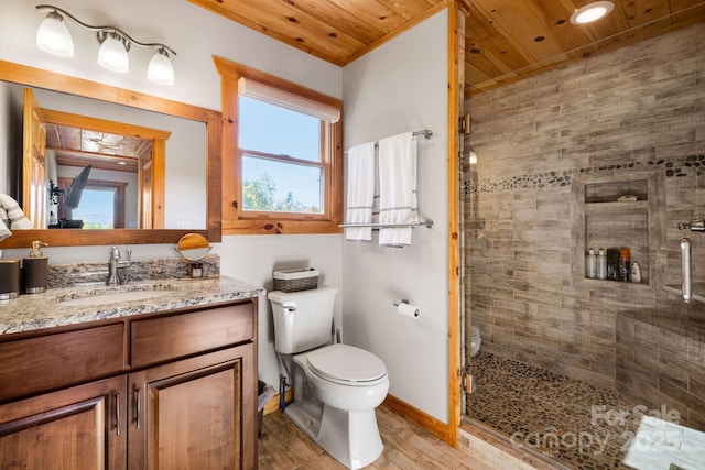 bathroom with vanity, a shower with shower door, wooden ceiling, and toilet