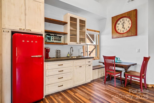 kitchen with sink, dark wood-type flooring, and fridge