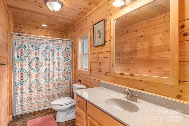 bathroom featuring wood walls, vanity, toilet, wooden ceiling, and a shower with curtain