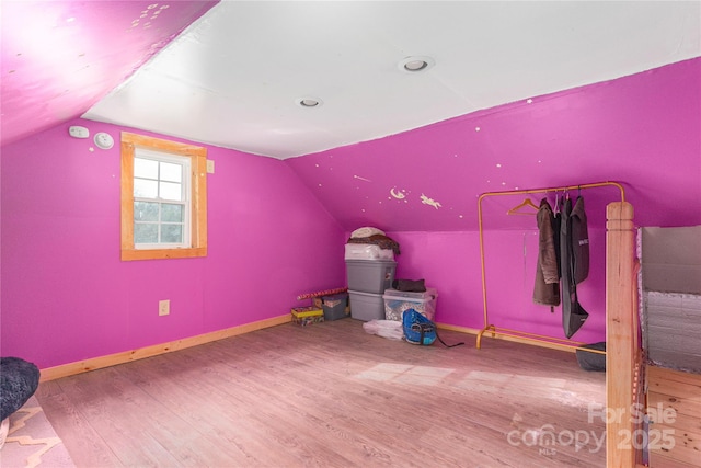 bonus room with lofted ceiling and hardwood / wood-style floors