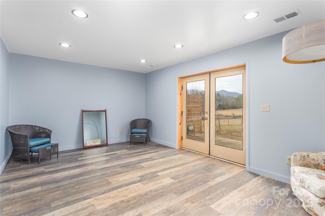 sitting room featuring hardwood / wood-style floors and french doors