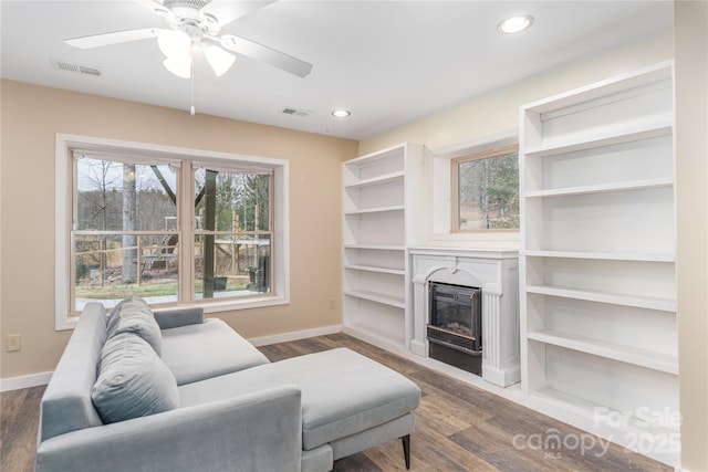 living room featuring dark hardwood / wood-style floors and ceiling fan