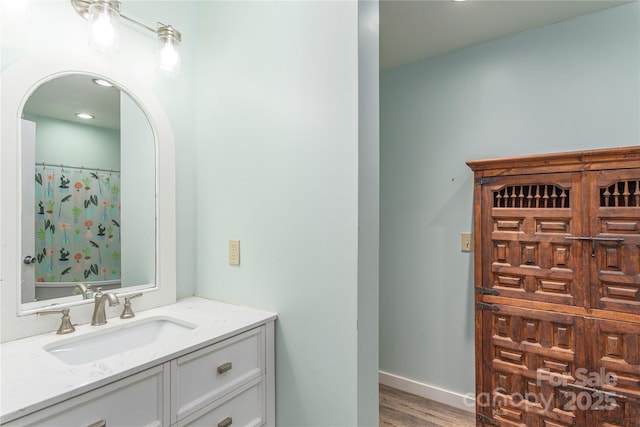 bathroom with vanity, wood-type flooring, and walk in shower