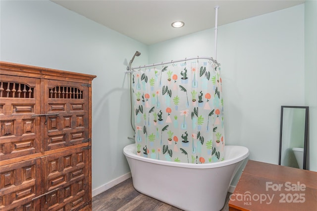 bathroom with shower with separate bathtub and hardwood / wood-style floors